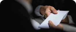 Dois homens executivos sentados trocando uma carta